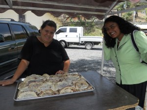 Marta and Claudia ready to pass out Baleadas to the children outside after Children's Church