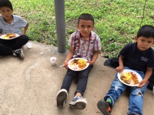 Our 10 year old boys enjoying their Tajo meal with rice and slaw.